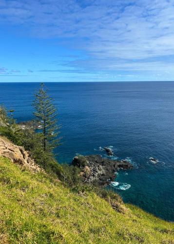 a view of the ocean from a hill at Sunset Villa Norfolk Island - a Mediterranean inspired villa in Burnt Pine