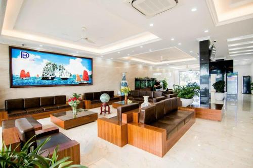 a living room with a large tv on the wall at Hạ Long Land Hotel in Ha Long