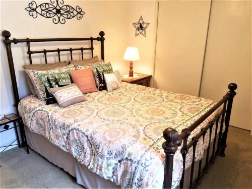 a bedroom with a bed with pillows on it at Pinecliff Retreat in Ruidoso