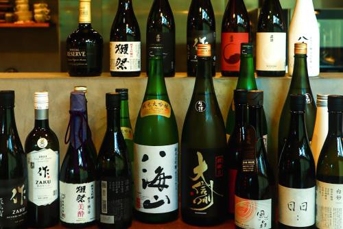 a bunch of bottles of wine on a shelf at Karuizawa Forest Seasons Villa in Karuizawa