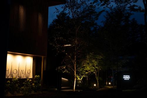a building at night with a sign on the side of it at Karuizawa Forest Seasons Villa in Karuizawa