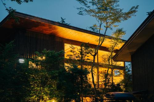 a house with lights on the side of it at Karuizawa Forest Seasons Villa in Karuizawa