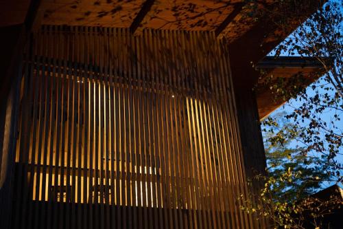 a building with a fence in front of it at Karuizawa Forest Seasons Villa in Karuizawa