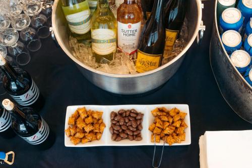a table with a plate of food and bottles of wine at Hotel Triton in San Francisco