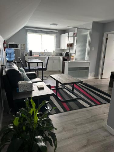 a living room with a couch and a table at Spotless 4 Bedrooms 4 Beds Sleep 8 in Winnipeg in Winnipeg