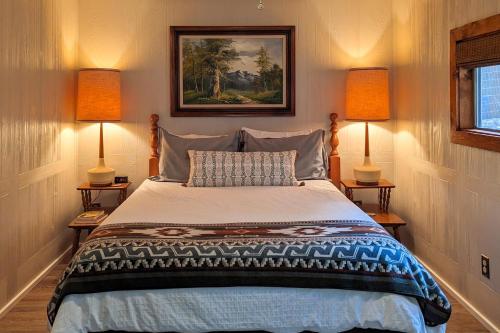 a bedroom with a bed with two lamps on both sides at Ruidoso River Trail Cabin in Ruidoso