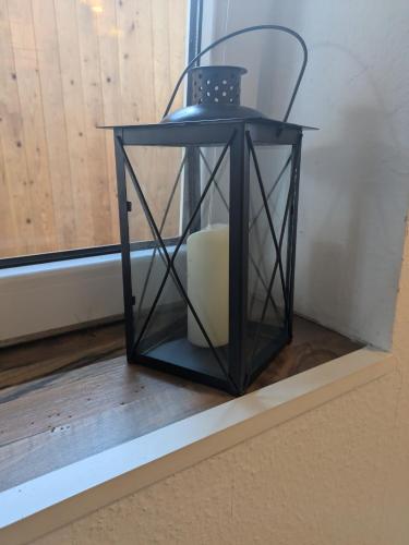 a black lantern sitting on a window sill at Gemütlicher Glücksplatz in Frielendorf