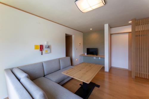 a living room with a couch and a table at 下本多町 庵 in Kanazawa
