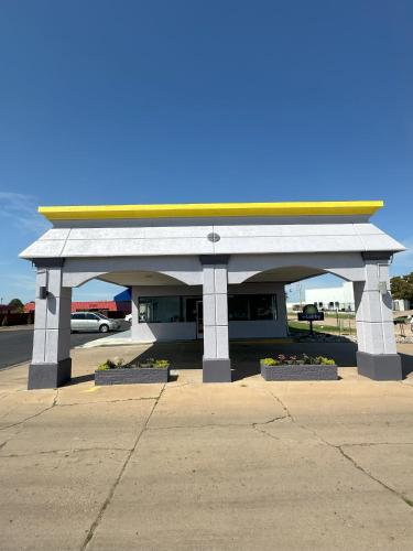 a gas station with a building with a yellow roof at Days Inn by Wyndham Salina South in Salina