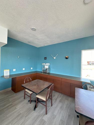 an empty waiting room with a table and chairs at Days Inn by Wyndham Salina South in Salina