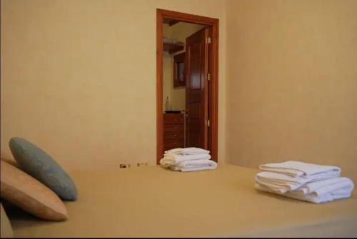 a stack of towels sitting on a counter in front of a mirror at O Cannulicchiu in Altofonte