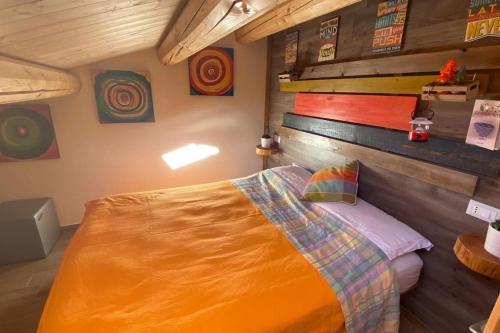 a bedroom with a bed and a wooden wall at Casa vacanze Santo Stefano di Sessanio in Santo Stefano di Sessanio