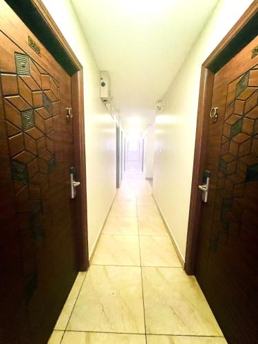 an empty hallway with two doors and a hallwayngth at Aura By Agira Hotels in Yelahanka