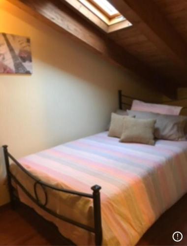 a large bed in a room with a ceiling at Miletto Holiday House in San Massimo