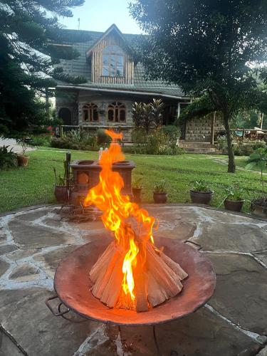 a fire pit in front of a house at Magical Malewa Retreat in Naivasha