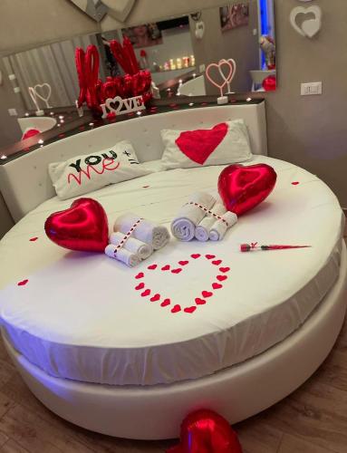 a white bed with red hearts on it at Sweet Room Affittacamere in San Severo