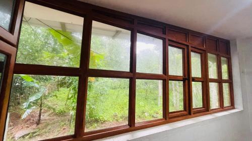 a window in a room with a view of a forest at Natures Lap in Pārassāla