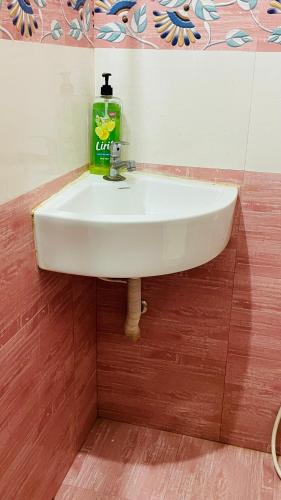 a sink in a bathroom with a bottle of soap at Natures Lap in Pārassāla