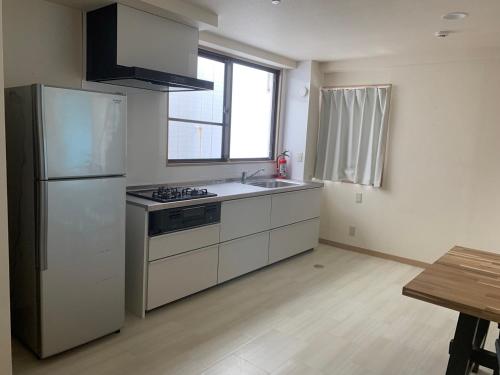 Una cocina o cocineta en STUDIO HINODECHO ｌ日の出町
