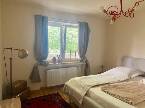 a bedroom with a bed and a window with blue curtains at Nett in Mettmann in Mettmann