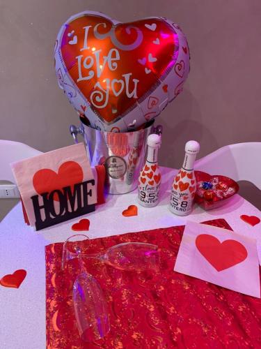 a table with a heart balloon and a love sign at Sweet Room Affittacamere in San Severo