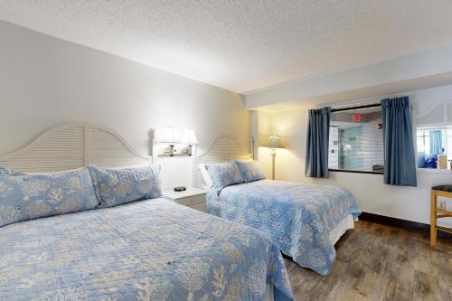 a hotel room with two beds and a window at Sand Dunes Resort 1450 in Myrtle Beach