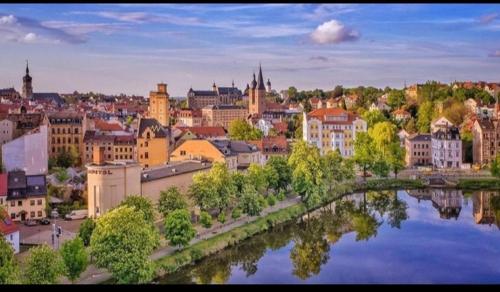 a view of a city with a bridge over a river at Monteurwohnung, Arbeiterunterkunft, Pension, Gästewohnung in Altenburg , Kurz u Langzeitmiete in Altenburg