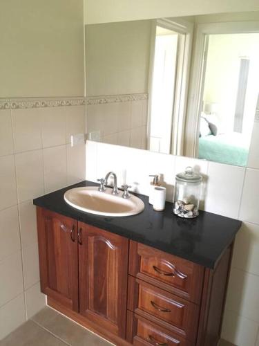 a bathroom with a sink and a mirror at Sea Valley Views in Port Lincoln