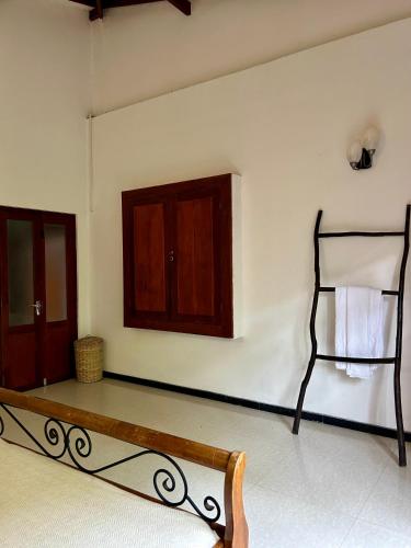 a room with a bench and a towel rack at One Bhakthi in Ahangama