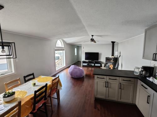 a kitchen and a dining room with a table and a dining room at EC Lodging in Yellowknife