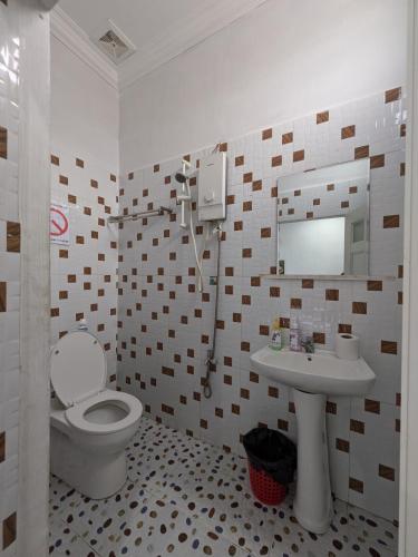 a bathroom with a toilet and a sink at Orchid 101 in Kampot