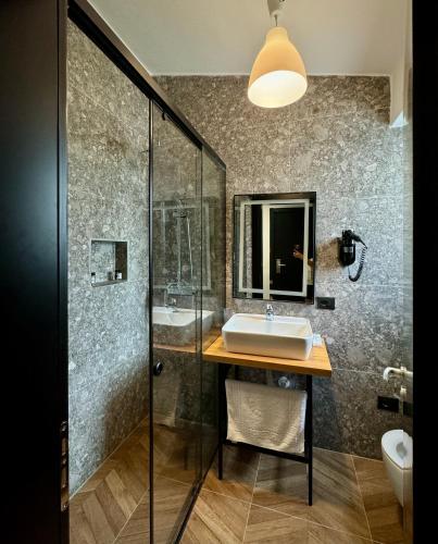a bathroom with a sink and a shower at Gogo's Boutique Hotel in Dhërmi