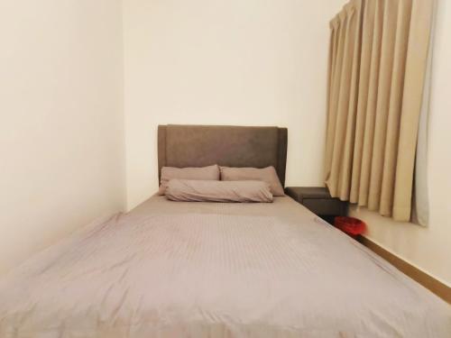 a bed in a small room with a large window at Bayu Temiang Luxury Design 7~8 Pax in Seremban