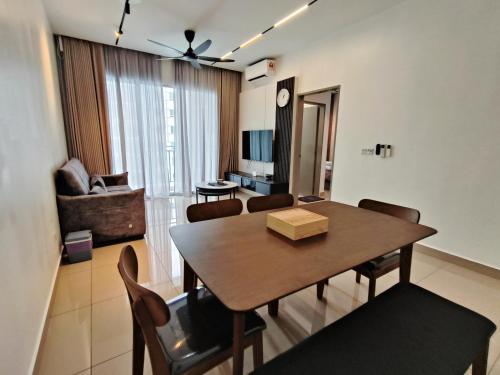 a living room with a dining table and a living room with a couch at Bayu Temiang Luxury Design 7~8 Pax in Seremban