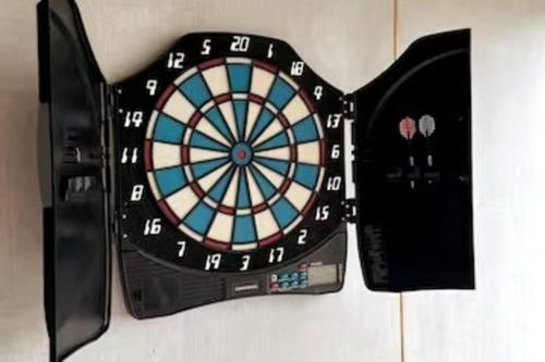 a dart board on a wall next to a knife at Georgetown Skypool Urban 2BR Family & Baby-Friendly 9pax Seaview Penang in Jelutong