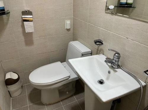 a bathroom with a white toilet and a sink at Maison Dongdaemun myeongdong hotel in Seoul
