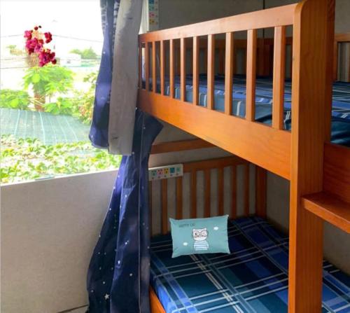 a bunk bed with a bag on the bottom bunk at Nomad Stay in Phan Rang