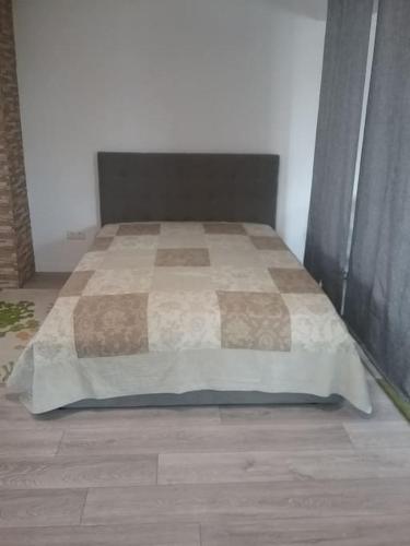 a bedroom with a bed with a blanket on it at Ferienwohnung OT Meersburg in Grasbeuren