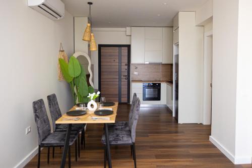 a dining room with a wooden table and chairs at iunn apartment 2 in Vlorë