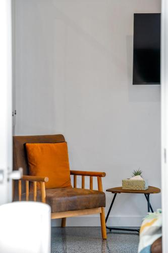 a living room with a chair and a table at Loft Retreat in Auckland
