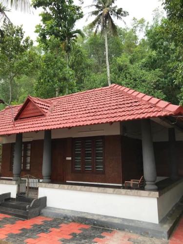 a small house with a red roof at Quite and peaceful in Perumanseri