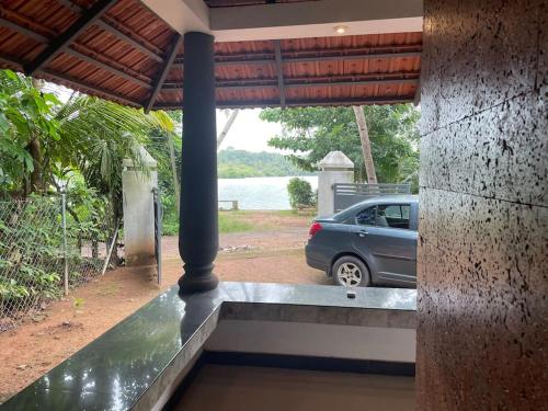 a car parked in the driveway of a house at Quite and peaceful in Perumanseri