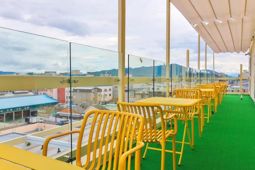 a row of tables and chairs on a balcony at Gridt Hotel & Home in Gyeongju