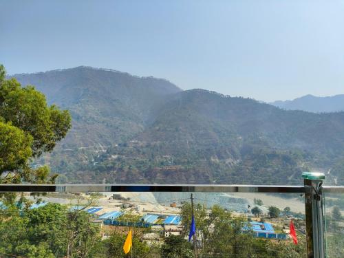 a view of a mountain range from a balcony at Bed iN Mountain - BNM Stays in Chutwāpīpal