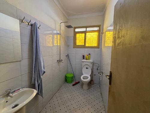 a bathroom with a toilet and a sink at Royal Bukoto Villas in Kampala