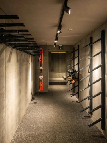 a hallway with a row of wine racks at Ski Inn Hakuba, Iwatake in Hakuba