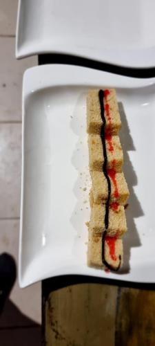 a sandwich is sitting on a white plate at Amanya 2 Bedroom Self Catering Tent in Amboseli