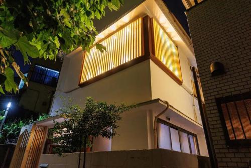 a building with a balcony on the side of it at SK House in Tokyo