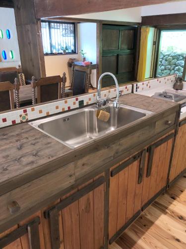 a kitchen sink with a wooden counter top at リラシャンティRelashanti in Soni