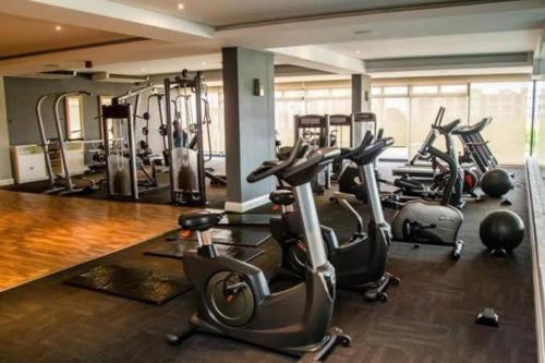 a gym with several exercise bikes in a room at Urban Park Accommodation in Durban